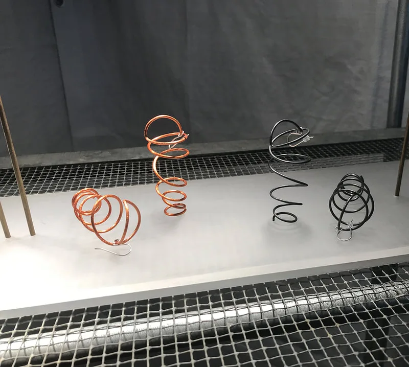 Swinging Coil Earrings on display